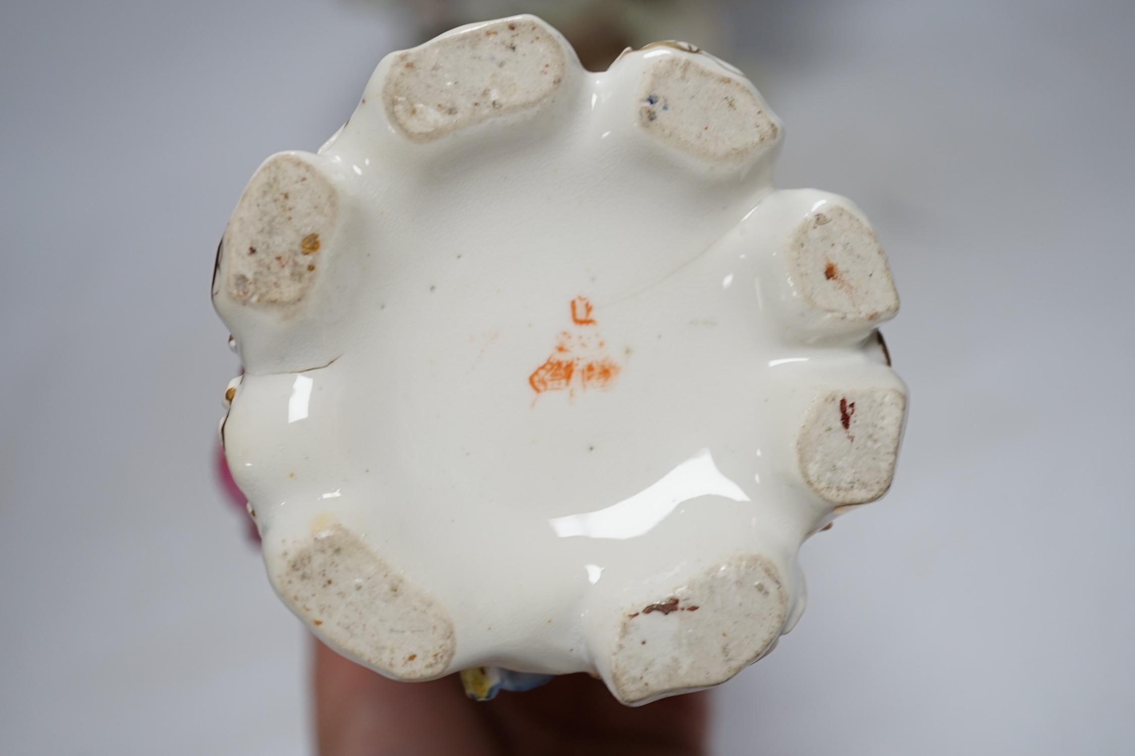 A porcelain shell-shaped centrepiece, a Dresden pill box, a pair of taper holders and a porcelain figure, tallest 21cm